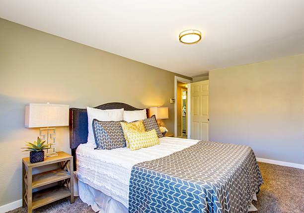 istock Small bedroom interior with gray walls and carpet floor. 591999488
