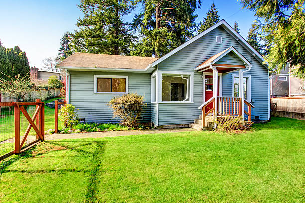 istock House with wooden deck. Front yard with flower bed 592000092