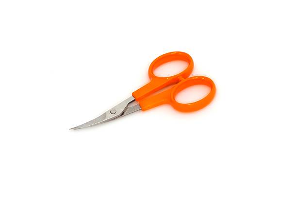 istock Nail scissors with orange handles on white background 592002790