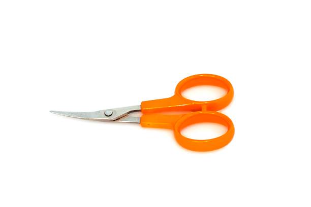 istock Nail scissors with orange handles on white background 592002796