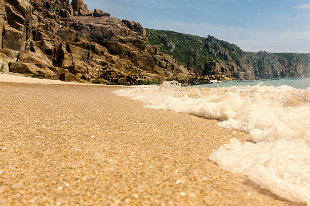 Breaking wave on the shoreline, Pedn Vounder Beach, Cornwall.