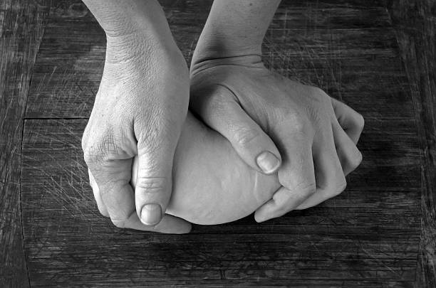 istock Woman hands kneading dough 592002894