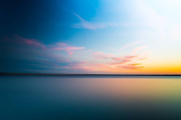 長時間露光で背景にぼやけてドラマチックな日没は抽象 - sunset sea tranquil scene sunrise ストックフォトと画像