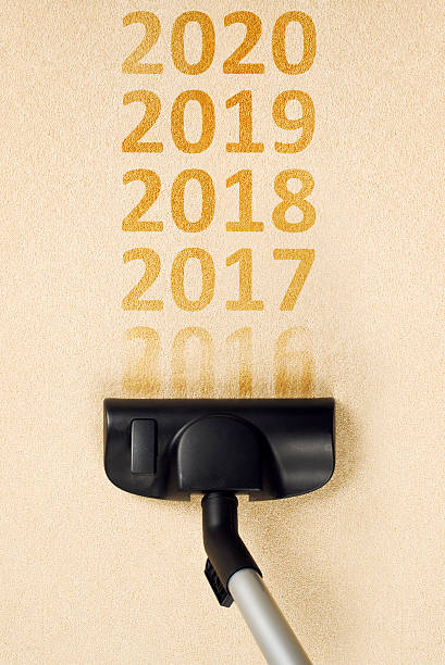istock Vacuum cleaning 2016 from carpet for happy new 2017 year 592004156