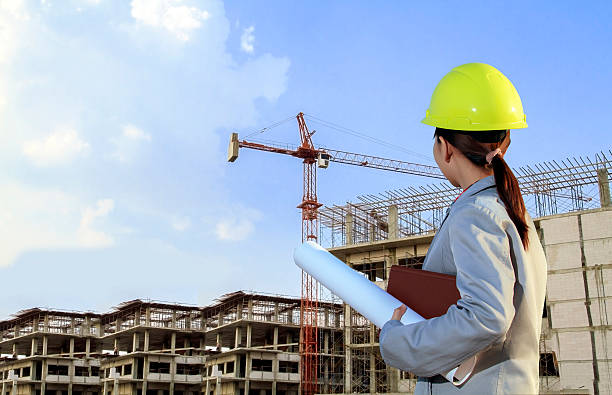 istock portrait women asia engineer working and holding blueprints at 592005550