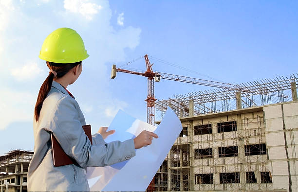 istock portrait women asia engineer working and holding blueprints 592005698