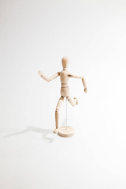 istock Wooden dummy running isolated on a white background 592006550