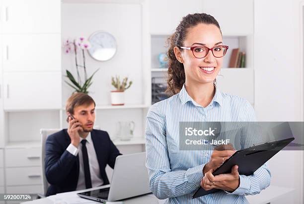 Cheerful Young Woman Manager Holding Cardboard In Office Stock Photo - Download Image Now