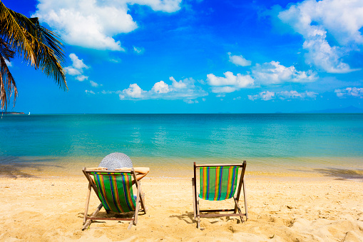 chairs on tropical coast. With sea background
