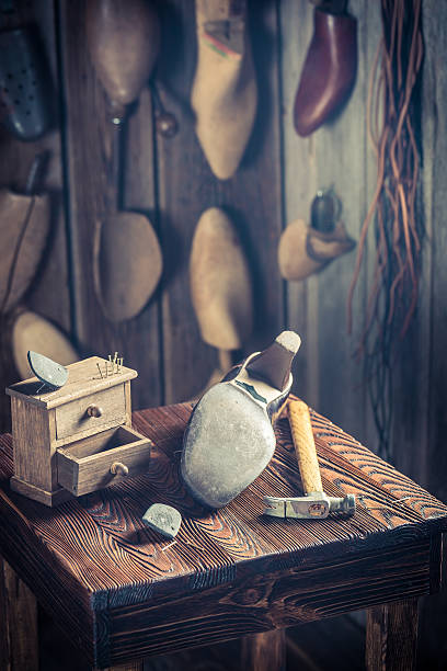 istock Shoes to repair in shoemakers workshop 592007606