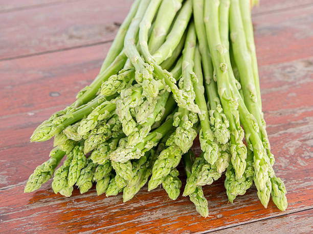 istock close-up Fresh asparagus, on Wood table. 592007848