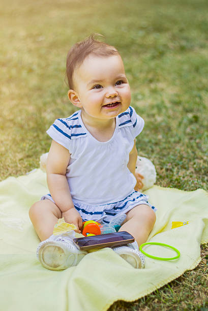 istock Happy one year old baby is playing in park. 592009106