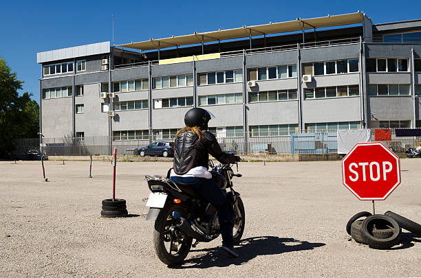 Young woman at a motorcycle in a course