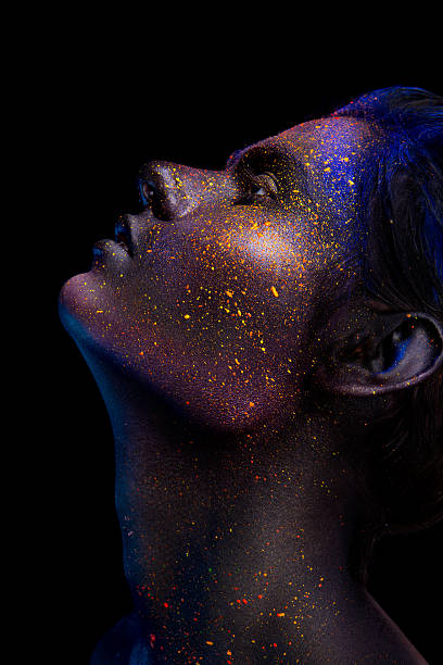 istock Glowing neon makeup with dramatic look in his eyes. 592011240