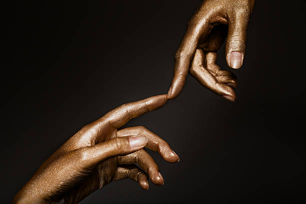 istock beautiful hands in golden paint 592015156