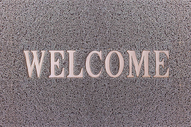 istock Welcome Gray Door Mat. Welcome Carpet Background. 592015518