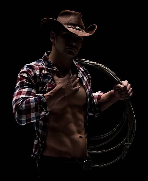 istock Muscular cowboy carrying lasso 592016744