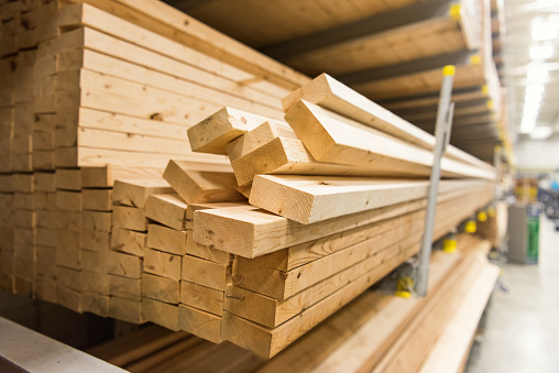 stacks of lumber in a large warehouse