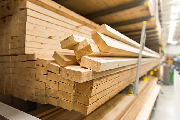 stacks of lumber in a large warehouse stock photo