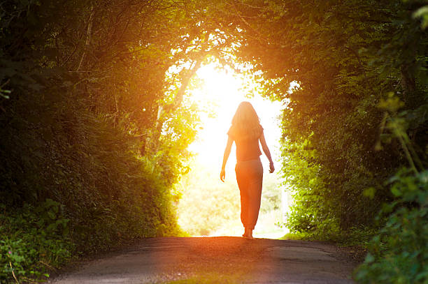 istock Girl walking towards the light 592018308