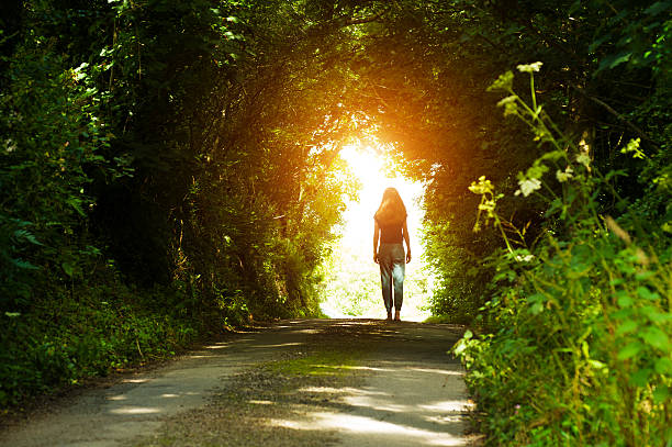 istock Girl walking towards the light 592018410