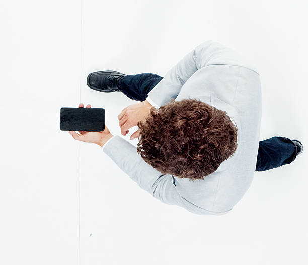 istock Above view of smart casual man using phone 592019008