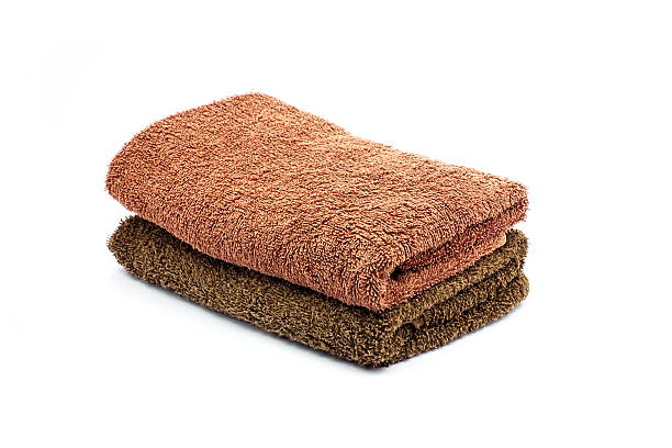 istock Stack of brown color towel on white background 592021738
