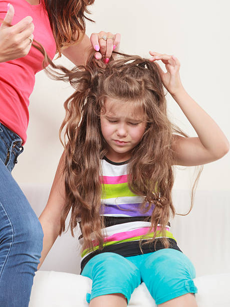 Mother combing hair for daughter Mother combing daughter, care about hairstyle. Girl is unhappy mom pulling her hair. Important role in child life. human hair women brushing beauty stock pictures, royalty-free photos & images