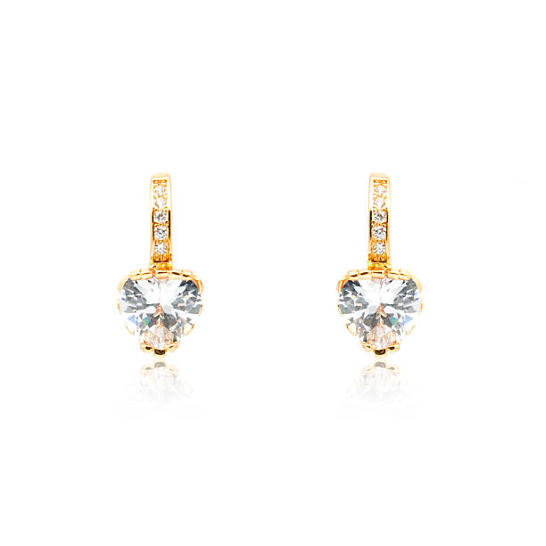 istock Pair of golden diamond earrings isolated on white 592025448