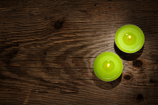 Small candles on wooden background