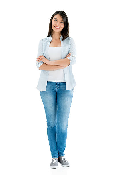 Casual Latin American woman smiling Casual fullbody Latin American woman smiling and looking at the camera with arms crossed - isolated over a white background women young women standing full length stock pictures, royalty-free photos & images