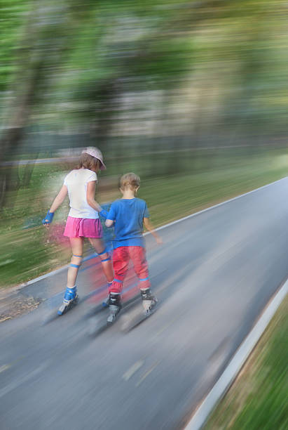 istock Little girl and boy roller skate. With motion blur. 592028836