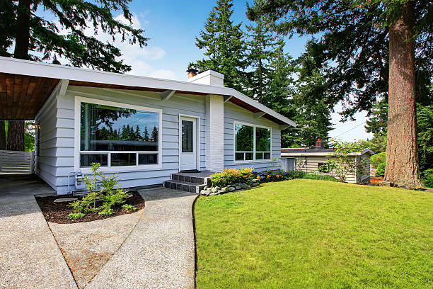 istock One level house with siding trim and well kept lawn 592029082