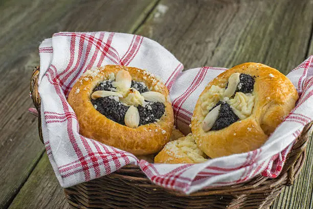 Czech Traditional Poppy Pie with Almond, Curd and Plum Jam in Wicker Basket on old wooden Table