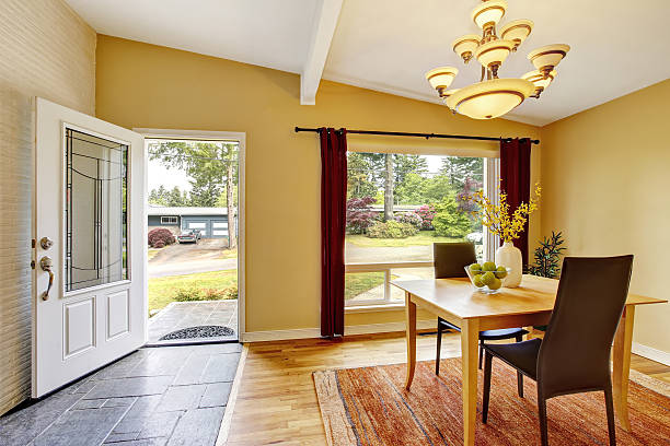 istock Dining room with table set, hardwood floor and red curtains. 592029826