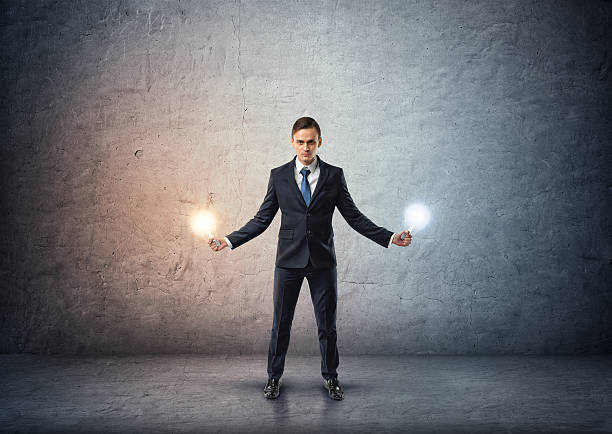 istock Front view of a businessman standing and holding glowing light 592030418