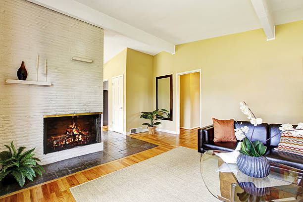 istock Modern living room with fireplace and glass coffee table. 592030536