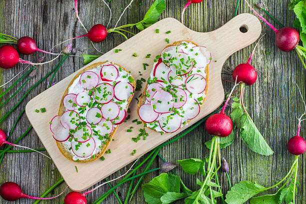 Wooden Board with Two Slices Bread with Curd Cheese, Radishes stock photo