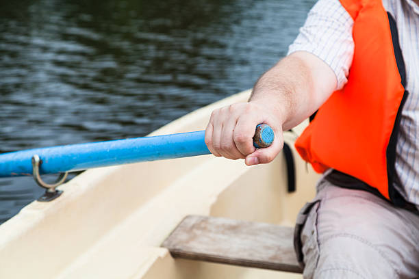 istock paddler with oar on boat during water walk 592031178
