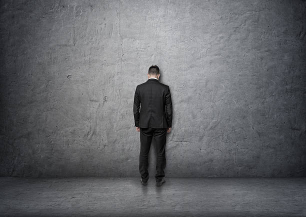 istock Back view businessman with bowed head standing in front of 592031202