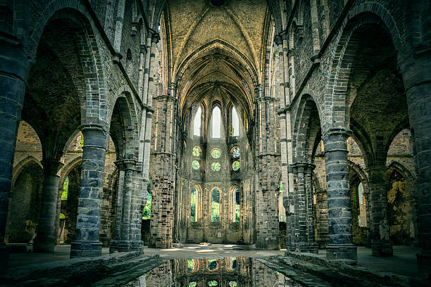 Dilapidated church in abandoned Villers Abbey Dilapidated church in abandoned Villers Abbey, Wallonia, Belgium (with dramatic light and HDR-effect) abbey stock pictures, royalty-free photos & images
