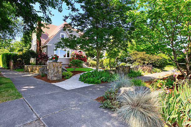 istock American craftsman house exterior. Nice landscape design around. 592031532