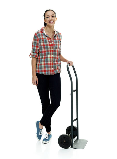 istock Smiling female holding  hand truck 592033292