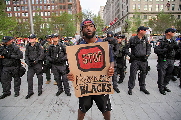 Republican National Convention, July 21, 2016 Cleveland, Ohio, USA - July 21, 2016: A lone demonstrator protests police killings of African Americans at the Public Square on the fourth and last afternoon of the Republican National Convention. As evening approached, the action in the square became smaller in scale and more personal. rnc stock pictures, royalty-free photos & images