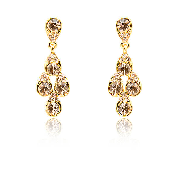istock Pair of golden diamond earrings isolated on white 592033714