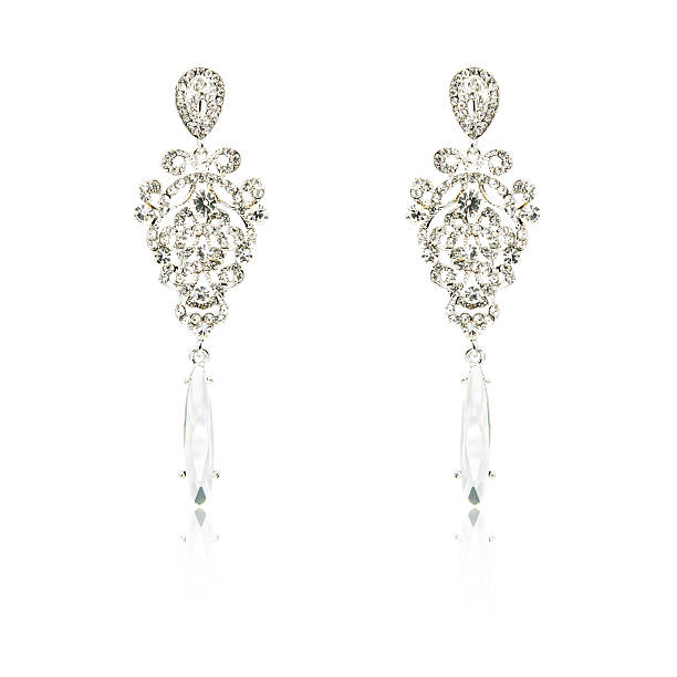 istock Pair of silver diamond earrings isolated on white 592033872