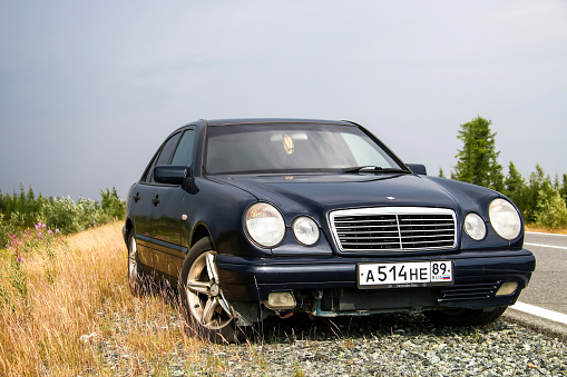 Novyy Urengoy, Russia - July 13, 2016: Motor car Mercedes-Benz W210 E240 is parked at the roadside.