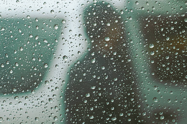 istock Rain drop at surface of a car. Water drop background. 592034258