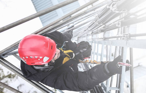 istock Telecommunication manual high worker engineer climbing an antenna 592034626