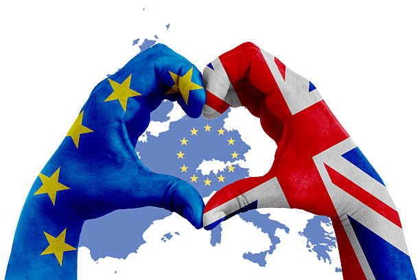 istock brexit, hands with heart shape and flag EU and uk 592034710